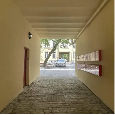 an empty hallway with a car parked in a building at Modern Vilnius Old Town apartment with free parking in Vilnius