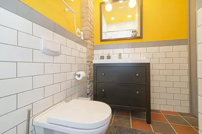 a bathroom with a toilet and a sink at Modern Vilnius Old Town apartment with free parking in Vilnius