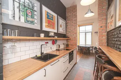 a kitchen with a sink and a counter at Modern Vilnius Old Town apartment with free parking in Vilnius