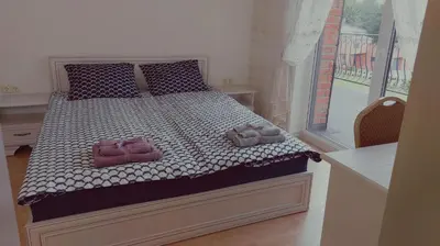 a bedroom with a bed with two towels on it at Marių įlanka in Marijampolė