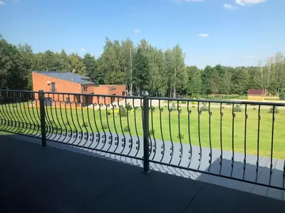 a fence in front of a field with sheep at Marių įlanka in Marijampolė