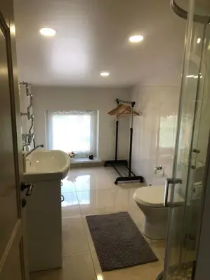 a bathroom with a toilet and a sink and a shower at Marių įlanka in Marijampolė