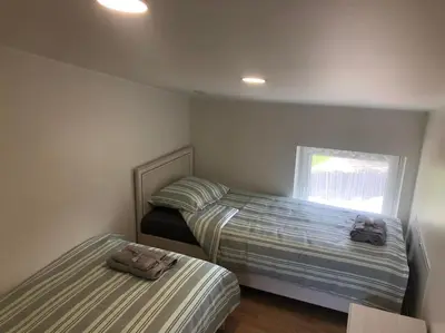 a bedroom with two beds and a window at Marių įlanka in Marijampolė