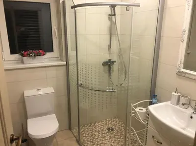 a bathroom with a shower and a toilet and a sink at Marių įlanka in Marijampolė