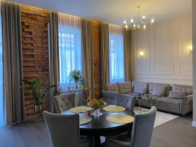 a living room with a table and chairs and a couch at Old town apartment in Kaunas
