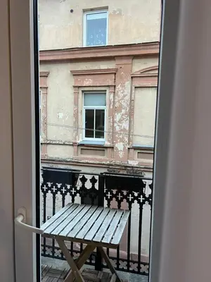 a window with a bench in front of a building at Old town apartment in Kaunas