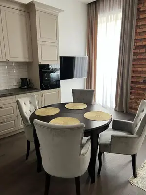 a kitchen with a table and chairs in a kitchen at Old town apartment in Kaunas