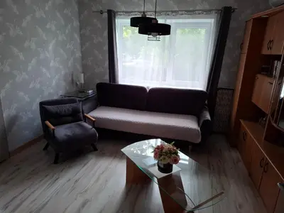 a living room with a couch and a chair at Lat4Rest in Prienai