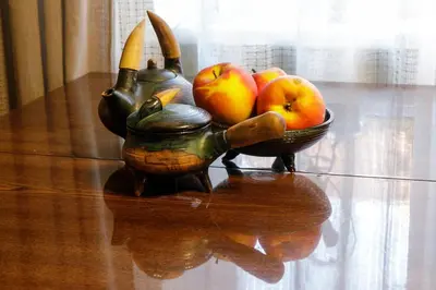 a table with a tea pot and a bowl of fruit at Lat4Rest in Prienai