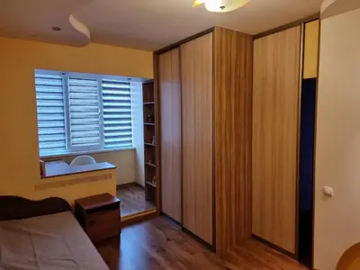 a bedroom with a bed and a closet and a window at Apartment Maya in Visaginas