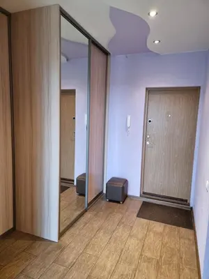 an empty room with a large mirror and a door at Apartment Maya in Visaginas