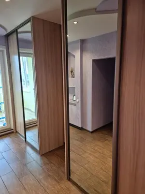 an empty room with a hallway with a mirror at Apartment Maya in Visaginas