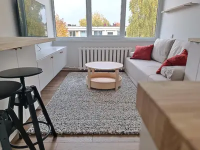 a living room with a couch and a table at Stylish Studio in Central Vilnius in Vilnius