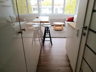 a living room with stools and a table and a couch at Stylish Studio in Central Vilnius in Vilnius