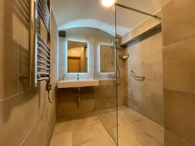 a bathroom with a sink and a glass shower at Modern guest house in city center I Room 1 in Vilnius