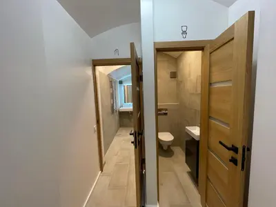 a small bathroom with a toilet and a door at Modern guest house in city center I Room 1 in Vilnius
