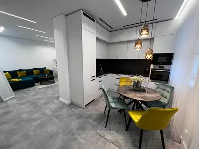 a kitchen and dining room with a table and chairs at ADIS Apartments in Druskininkai