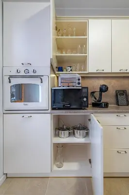 a kitchen with a white stove and a microwave at Archcathedral apartment by Polo Apartments in Kaunas