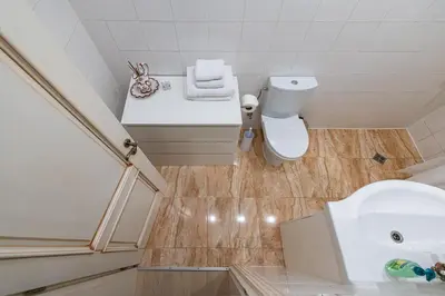a small bathroom with a toilet and a sink at Archcathedral apartment by Polo Apartments in Kaunas