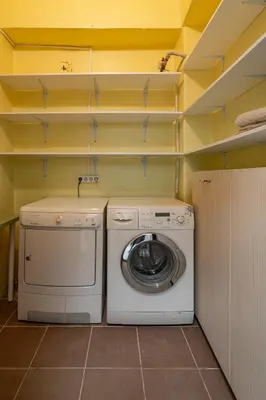 a washer and dryer in a small laundry room at Archcathedral apartment by Polo Apartments in Kaunas
