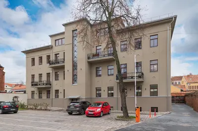 a building with cars parked in front of it at Archcathedral apartment by Polo Apartments in Kaunas