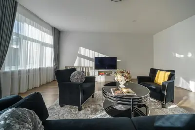 a living room with a couch and chairs and a table at Nica Apartment in Šiauliai