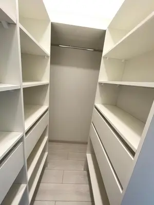a walk in closet with white shelves at Central apartment in Vilnius