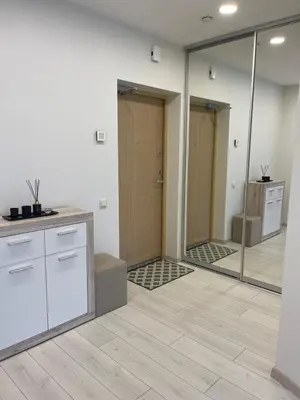 an empty room with mirrors in a room with a bathroom at Central apartment in Vilnius