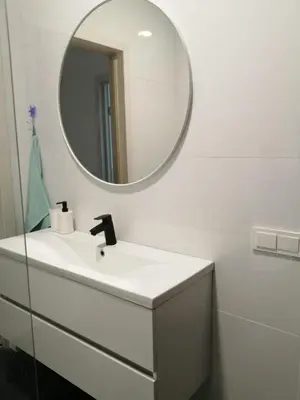a bathroom with a white sink and a mirror at SPA TOWN house I in Druskininkai