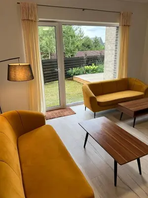 a living room with two couches and a coffee table at SPA TOWN house I in Druskininkai