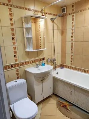 a bathroom with a toilet and a sink and a tub at Apartamentai šalia parko in Šiauliai