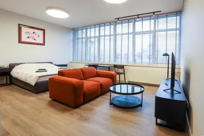 a bedroom with a bed and a couch and a table at Studio 501 in Kaunas
