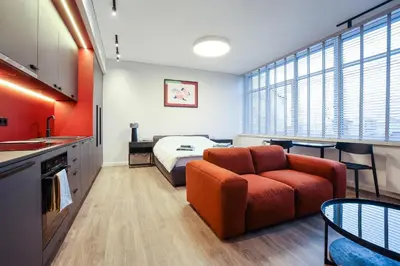 a living room with a couch and a bed at Studio 501 in Kaunas