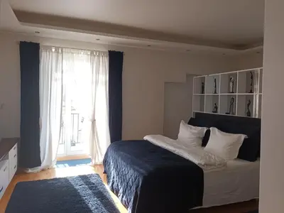 a bedroom with a bed and a large window at Skaistakalnio apartamentai in Panevėžys