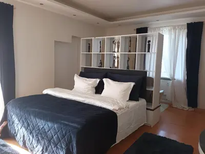 a bedroom with a large bed with white pillows at Skaistakalnio apartamentai in Panevėžys