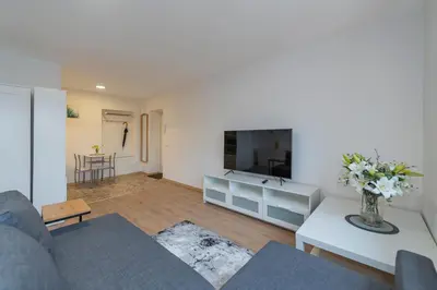 a living room with a couch and a tv at Archcathedral studio apartment by Polo Apartments in Kaunas