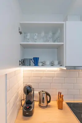 a kitchen counter with a tea kettle and cups on it at Archcathedral studio apartment by Polo Apartments in Kaunas