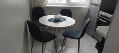 a small kitchen with a table and four chairs at Pakeliui in Kaunas