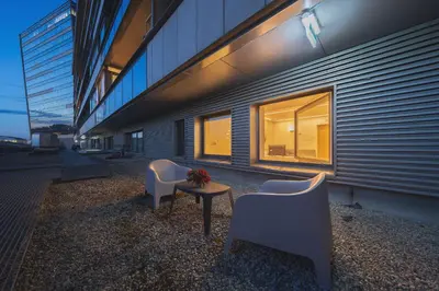 two chairs and a table in front of a building at Gynėjų Self Check-in Apartments - Lollo Stay in Vilnius