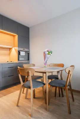 a dining room with a table and chairs at Gynėjų Self Check-in Apartments - Lollo Stay in Vilnius