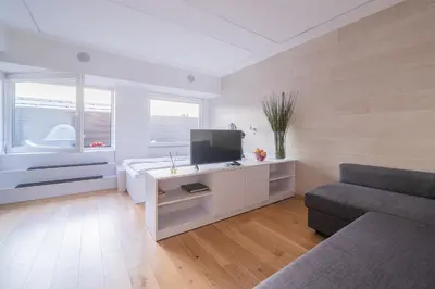 a living room with a tv and a couch at Gynėjų Self Check-in Apartments - Lollo Stay in Vilnius