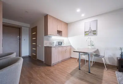 a kitchen with a table and a dining room at Gynėjų Self Check-in Apartments - Lollo Stay in Vilnius