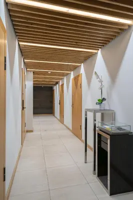 an office hallway with wooden ceilings and a tile floor at Gynėjų Self Check-in Apartments - Lollo Stay in Vilnius