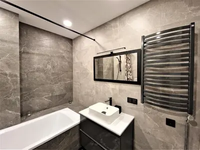 a bathroom with a sink and a bath tub at Aurea apartment in Vilnius