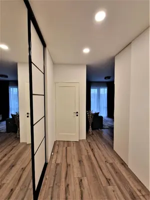 an empty room with a door and a mirror at Aurea apartment in Vilnius