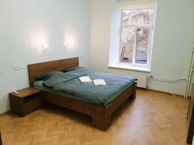 a bedroom with a bed with two towels on it at Modern Flat by Lukiskiu square in Vilnius