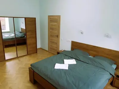 a bedroom with a bed with two towels on it at Modern Flat by Lukiskiu square in Vilnius