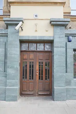 a wooden door on the side of a building at Modern Flat by Lukiskiu square in Vilnius
