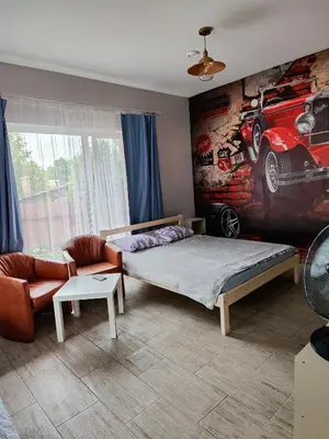 a bedroom with a bed and a painting on the wall at Comfort Mile Apartments in Vilnius