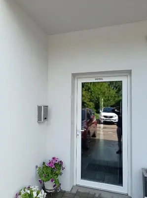 a door to a parking lot with cars on the street at Comfort Mile Apartments in Vilnius